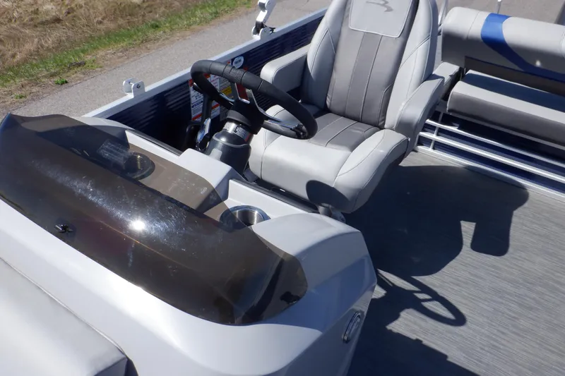 Slide: The Image of 2022 Bennington SX 22 Swingback boat interior with steering wheel and captain's chair. - 24