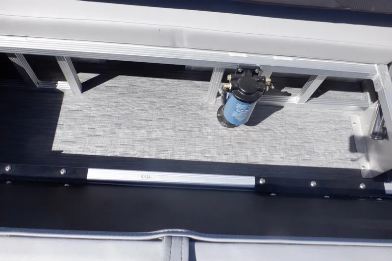 Slide: The Image of 2022 Bennington SX 22 Swingback interior storage compartment with visible pump mechanism. - 30
