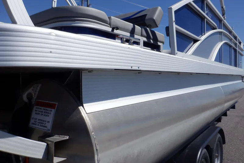 Slide: The Image of 2022 Bennington SX 22 Swingback pontoon boat, side view, showcasing sleek design and seating. - 37
