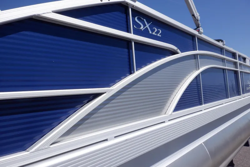 Slide: The Image of 2022 Bennington SX 22 Swingback pontoon boat with sleek blue and silver design. - 38