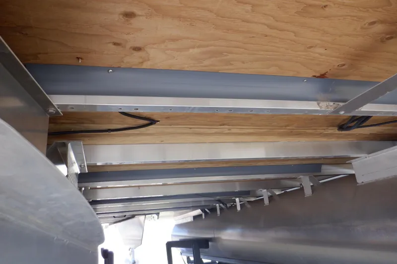 Slide: The Image of Underneath view of 2022 Bennington SX 22 Swingback boat, showcasing structural details and wiring. - 42