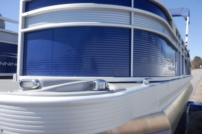 Slide: The Image of 2022 Bennington SX 22 Swingback pontoon boat with sleek blue and silver design. - 44