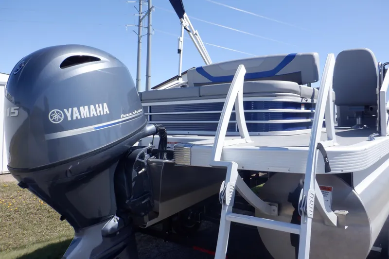 Slide: The Image of 2022 Bennington SX 22 Swingback pontoon boat with Yamaha outboard motor, docked under clear sky. - 5