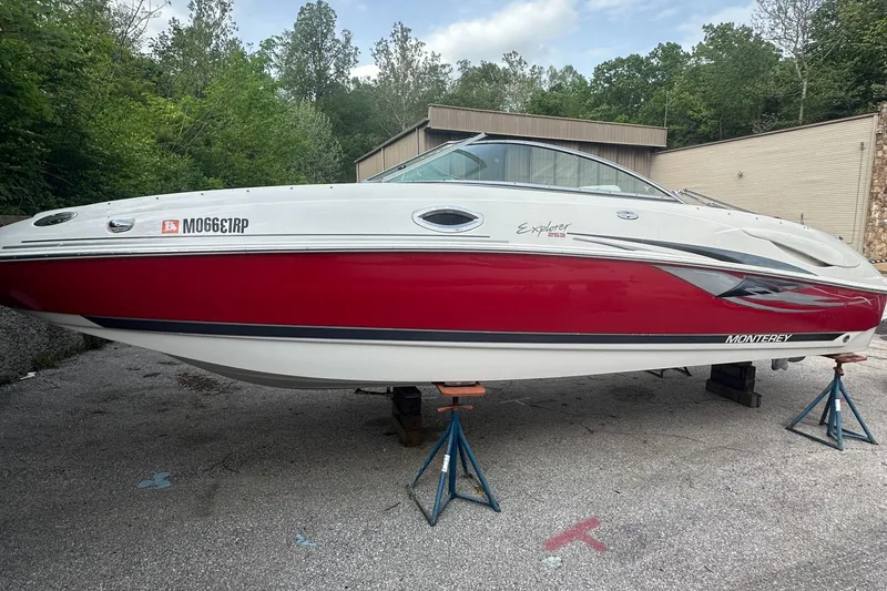 Slide: The Image of 2004 Monterey 253 Explorer Sport boat on stands, red and white exterior. - 0