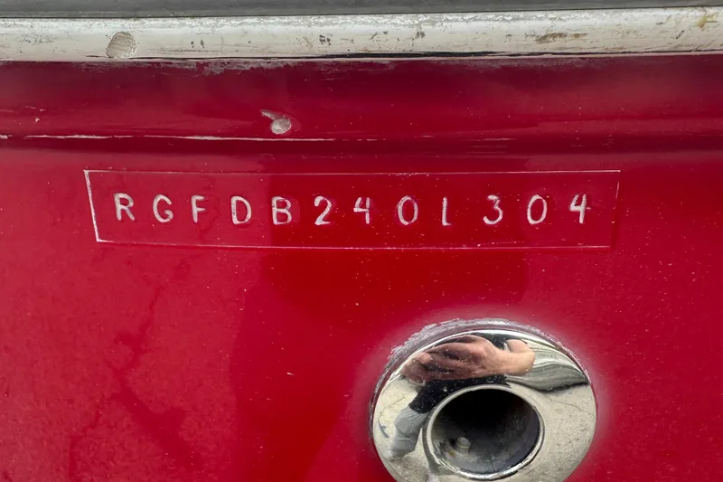 Slide: The Image of 2004 Monterey 253 Explorer Sport boat hull identification number on red surface. - 15