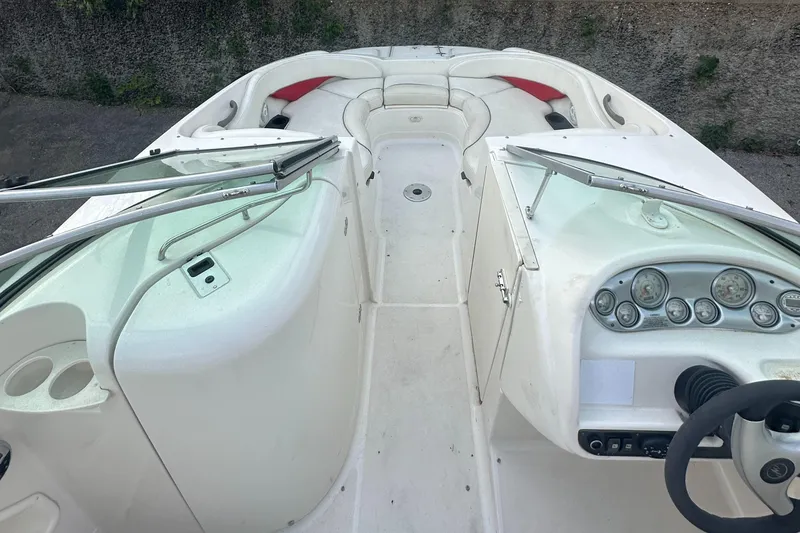 Slide: The Image of 2004 Monterey 253 Explorer Sport boat interior with dashboard and seating. - 4