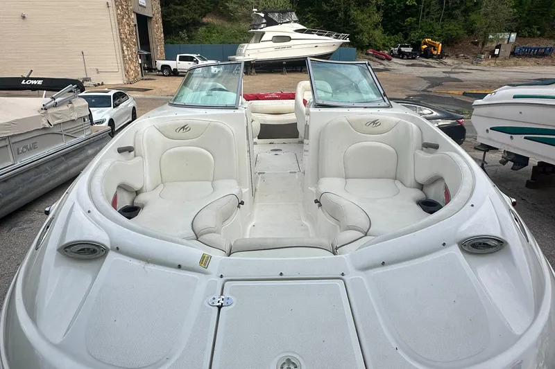 Slide: The Image of 2004 Monterey 253 Explorer Sport boat with spacious seating in a marina setting. - 5