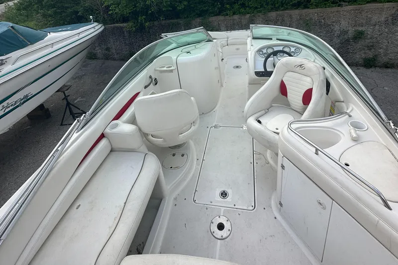 Slide: The Image of 2004 Monterey 253 Explorer Sport boat interior with white seating and dashboard. - 7