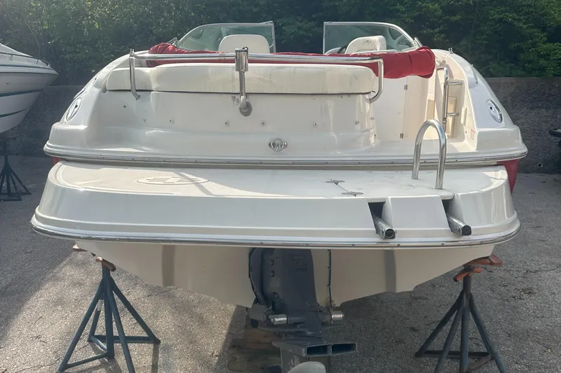 Slide: The Image of 2004 Monterey 253 Explorer Sport boat on stands, rear view, outdoors. - 9