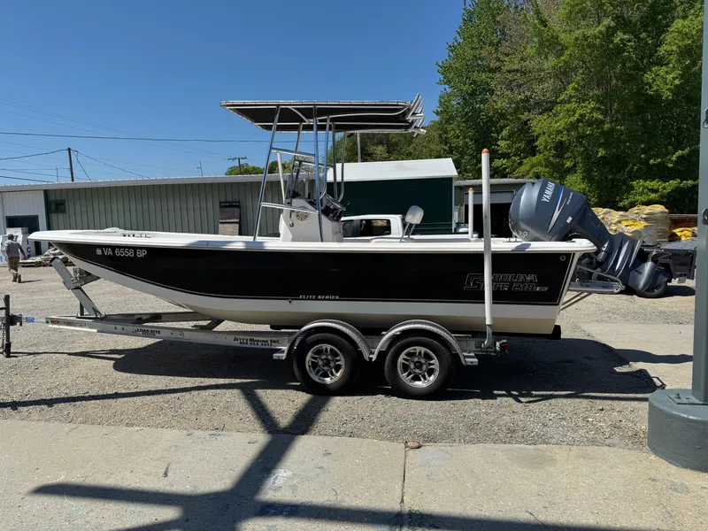 Slide: The Image of 2010 Carolina Skiff 218 DLV Elite boat on trailer, parked outdoors. - 0