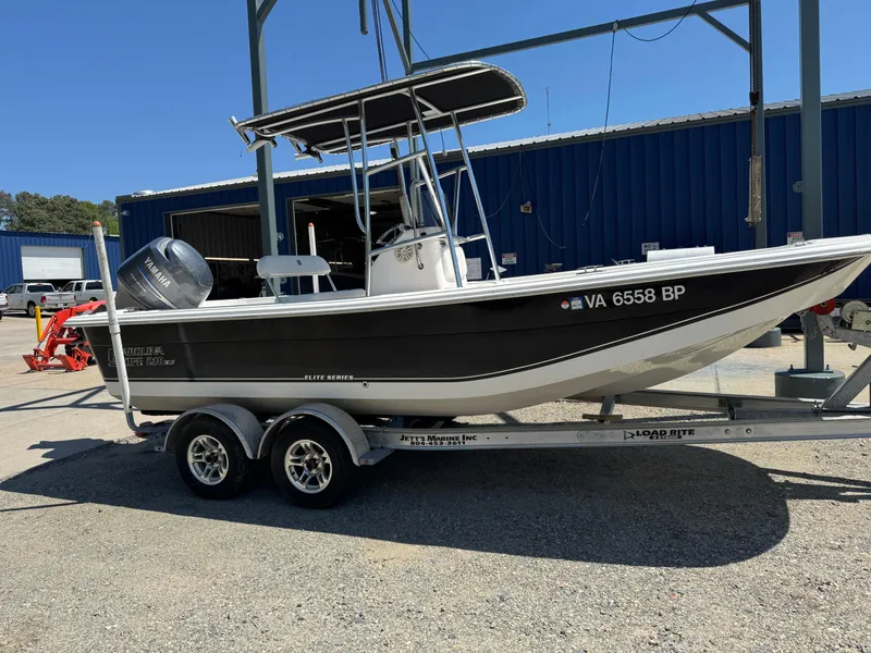 Slide: The Image of 2010 Carolina Skiff 218 DLV Elite boat on trailer, parked outdoors. - 3
