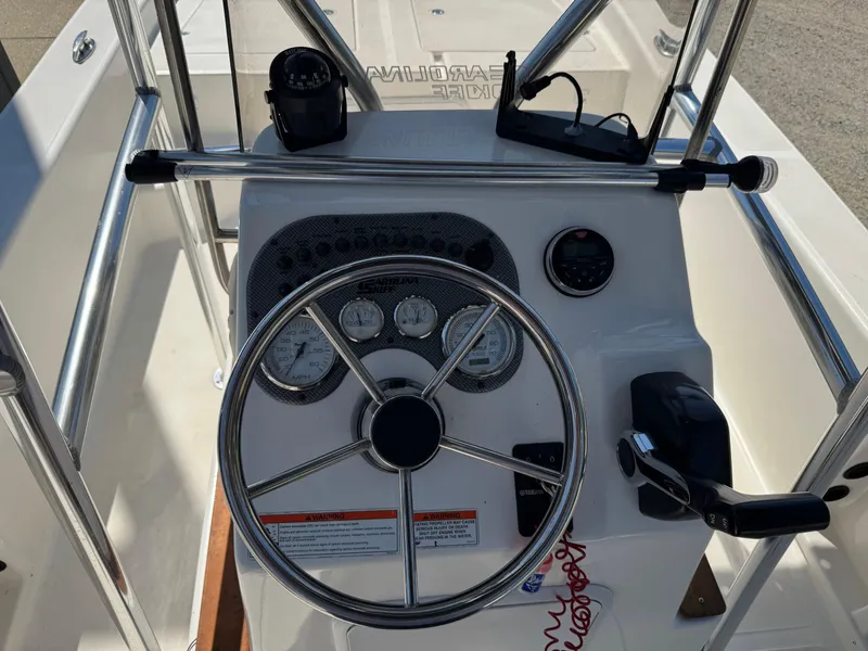 Slide: The Image of 2010 Carolina Skiff 218 DLV Elite boat console with steering wheel and gauges. - 5
