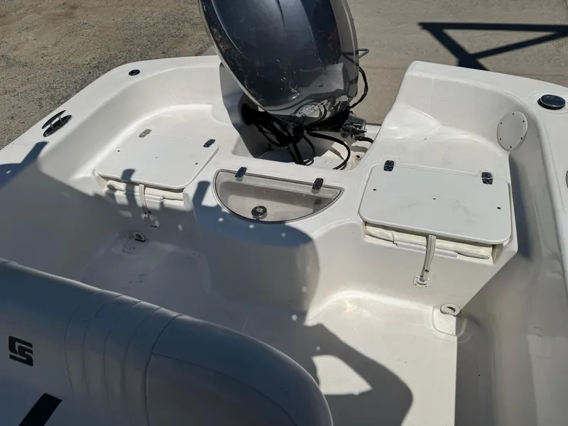 Slide: The Image of 2010 Carolina Skiff 218 DLV Elite boat interior with seating and storage compartments. - 6