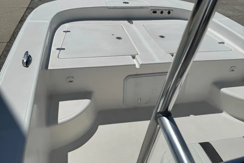 Slide: The Image of 2010 Carolina Skiff 218 DLV Elite boat deck with storage compartments and railing. - 8