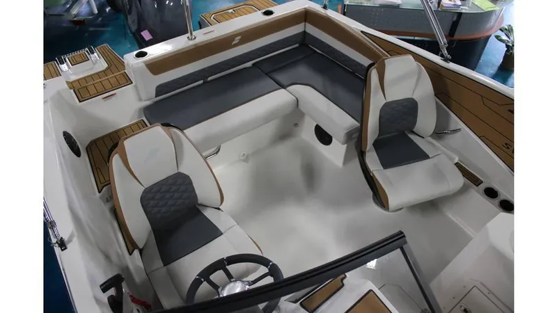 Slide: The Image of 2025 Starcraft SVX 190 OB DC boat interior with modern seating and steering wheel. - 5