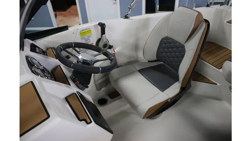Slide: The Image of 2025 Starcraft SVX 190 OB DC boat interior with steering wheel and cushioned seat. - 6