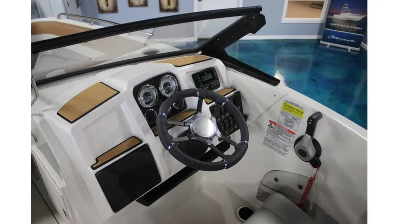 Slide: The Image of 2025 Starcraft SVX 190 OB DC boat dashboard with steering wheel and controls. - 7