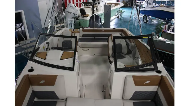 Slide: The Image of 2025 Starcraft SVX 190 OB DC boat interior with dual consoles and seating. - 8