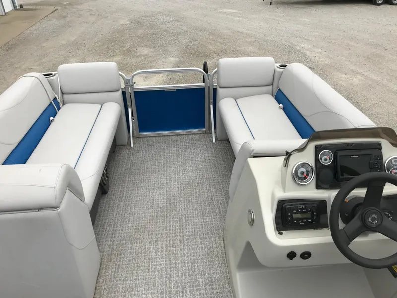 Slide: The Image of 2019 Avalon Venture Quad Lounge boat interior with seating and steering console. - 12