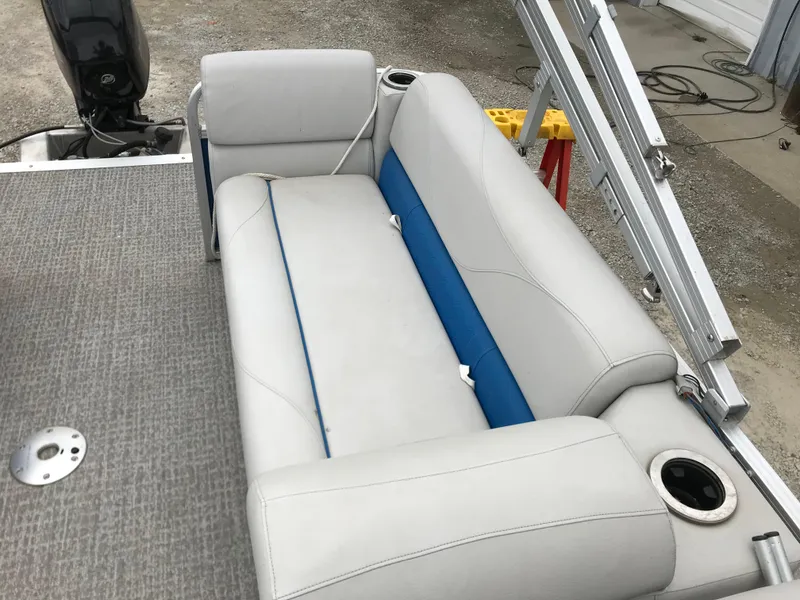 Slide: The Image of 2019 Avalon Venture Quad Lounge boat interior with gray and blue seating. - 13
