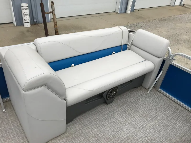 Slide: The Image of 2019 Avalon Venture Quad Lounge boat interior with white and blue seating. - 17