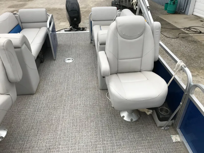 Slide: The Image of 2019 Avalon Venture Quad Lounge boat interior with plush seating and carpeted floor. - 18