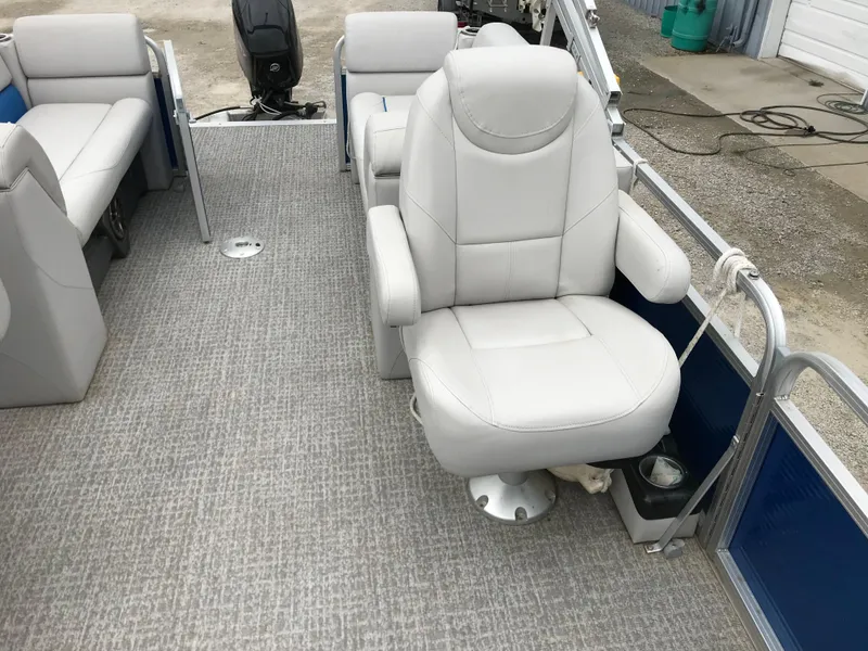 Slide: The Image of 2019 Avalon Venture Quad Lounge boat interior with plush seating and carpeted flooring. - 20