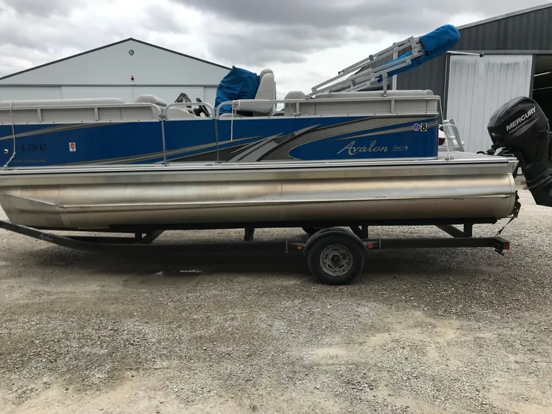 Slide: The Image of 2019 Avalon Venture Quad Lounge 20' pontoon boat on trailer, parked outdoors. - 3