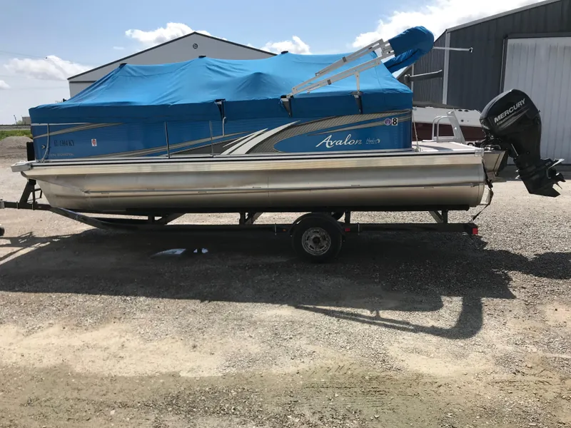Slide: The Image of 2019 Avalon Venture Quad Lounge 20' pontoon boat with blue cover on trailer. - 5