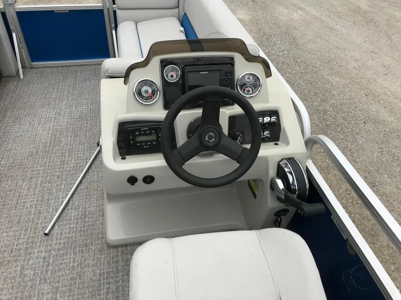 Slide: The Image of 2019 Avalon Venture Quad Lounge boat dashboard with steering wheel and controls. - 8