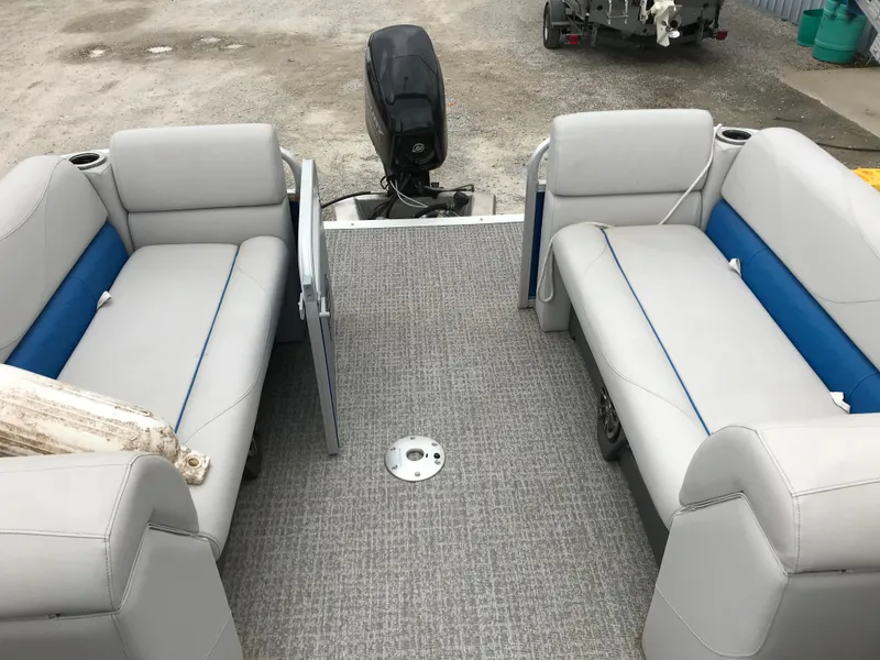 Slide: The Image of 2019 Avalon Venture Quad Lounge boat interior with gray and blue seating. - 9