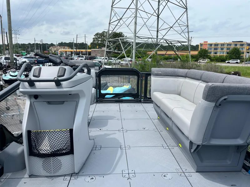 Slide: The Image of 2023 Sea-Doo Switch Compact interior with steering console and seating, outdoor setting. - 4