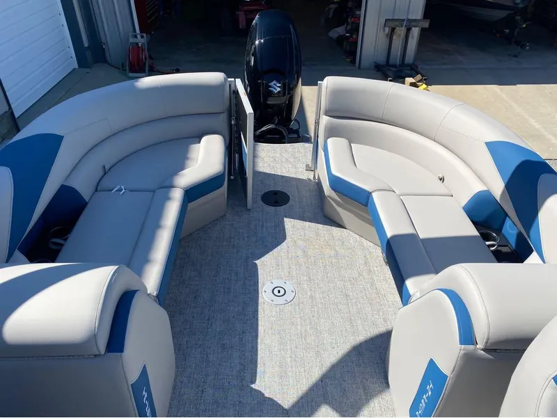 Slide: The Image of 2024 Trifecta 24 RF LE 2.75 pontoon boat interior with blue and gray seating. - 13