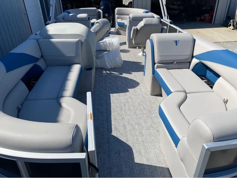 Slide: The Image of 2024 Trifecta 24 RF LE 2.75 pontoon boat interior with gray and blue seating. - 15