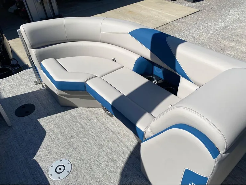 Slide: The Image of 2024 Trifecta 24 RF LE 2.75 boat interior with gray and blue seating. - 16