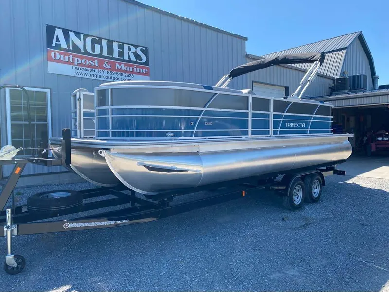 Slide: The Image of 2024 Trifecta 24 RF LE 2.75 pontoon boat on trailer at Anglers Outpost & Marine. - 5