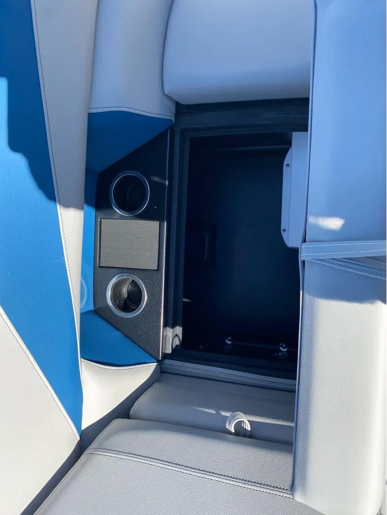 Slide: The Image of 2024 Trifecta 24 RF LE 2.75 boat interior with cup holders and storage compartment. - 8