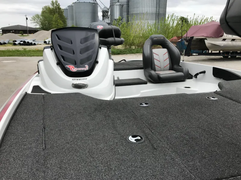 Slide: The Image of 2017 Nitro Z18 boat with sleek seating and spacious deck, parked outdoors. - 12