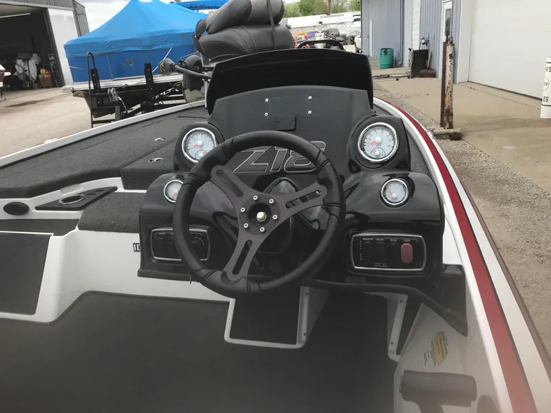 Slide: The Image of 2017 Nitro Z18 boat dashboard with steering wheel and gauges in a marina setting. - 16