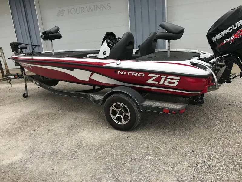 Slide: The Image of Red 2017 Nitro Z18 boat with Mercury Pro XS engine on a trailer. - 2