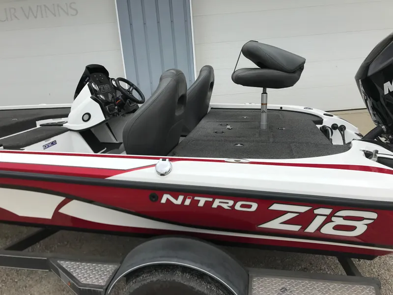 Slide: The Image of 2017 Nitro Z18 boat with red and white design, featuring comfortable seating and steering console. - 20