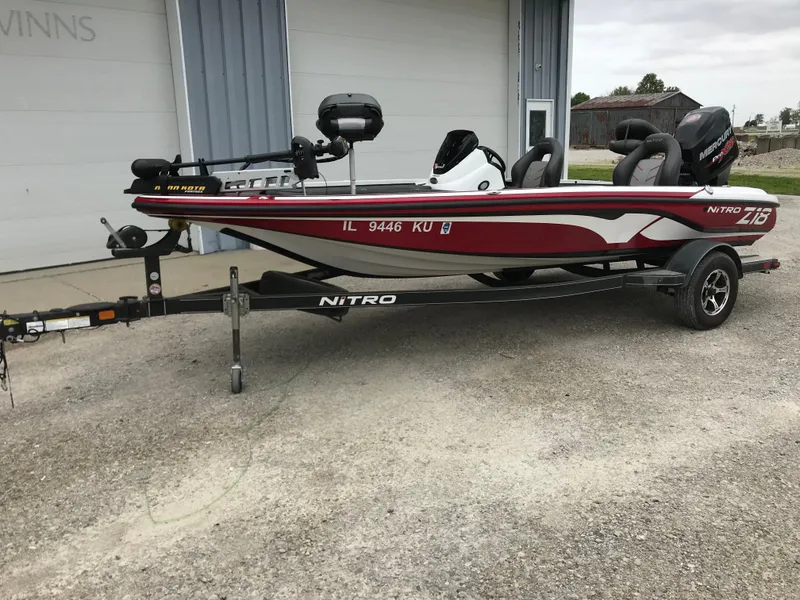 Slide: The Image of 2017 Nitro Z18 boat on trailer, red and white design, parked outdoors. - 28