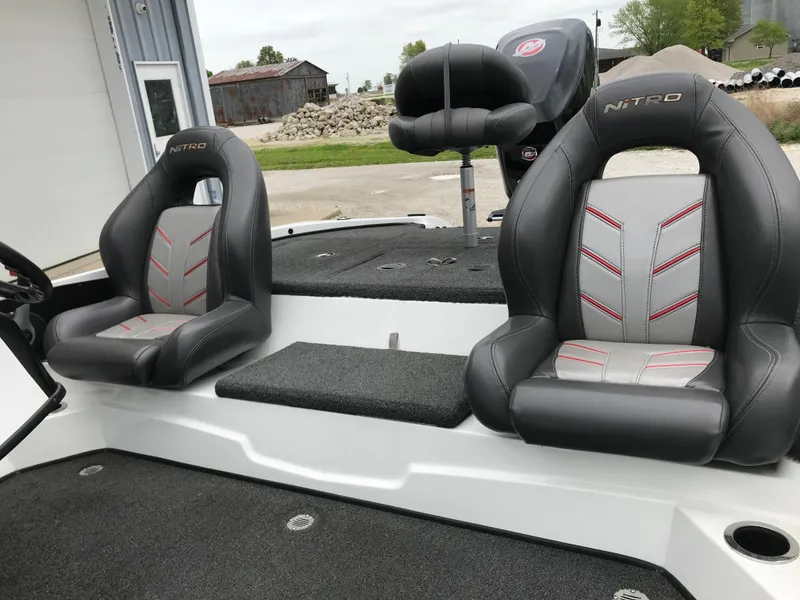 Slide: The Image of 2017 Nitro Z18 boat seats with black and gray upholstery, featuring red stitching. - 7