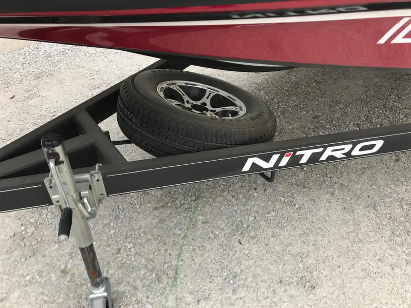 Slide: The Image of Trailer of a 2017 Nitro Z18 boat with spare tire on gravel. - 9