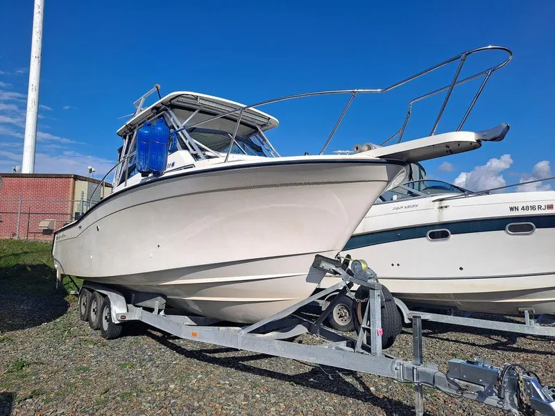 Slide: The Image of 1991 Grady-White 280 Marlin boat on trailer, parked outdoors under blue sky. - 1