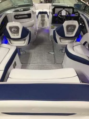 Slide: The Image of 2025 Crownline 260 XSS boat interior with blue and white seating, modern design. - 2