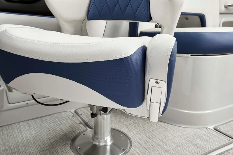 Slide: The Image of Captain's chair on 2025 Crownline 260 XSS boat, featuring blue and white upholstery. - 3