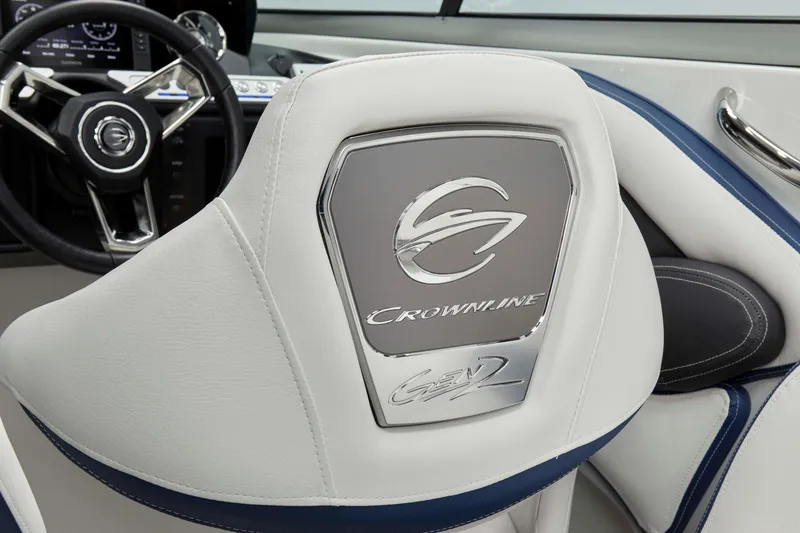 Slide: The Image of 2025 Crownline 260 XSS boat interior with branded seat and steering wheel. - 7