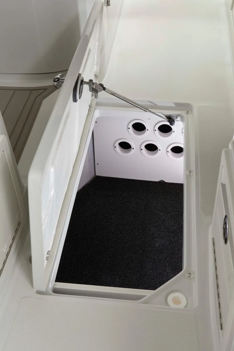 Slide: The Image of 2025 Finseeker 260 DC boat storage compartment with multiple rod holders. - 11