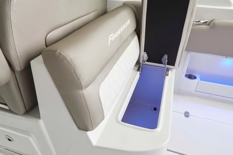 Slide: The Image of 2025 Finseeker 260 DC boat interior with cushioned seating and storage compartment. - 13